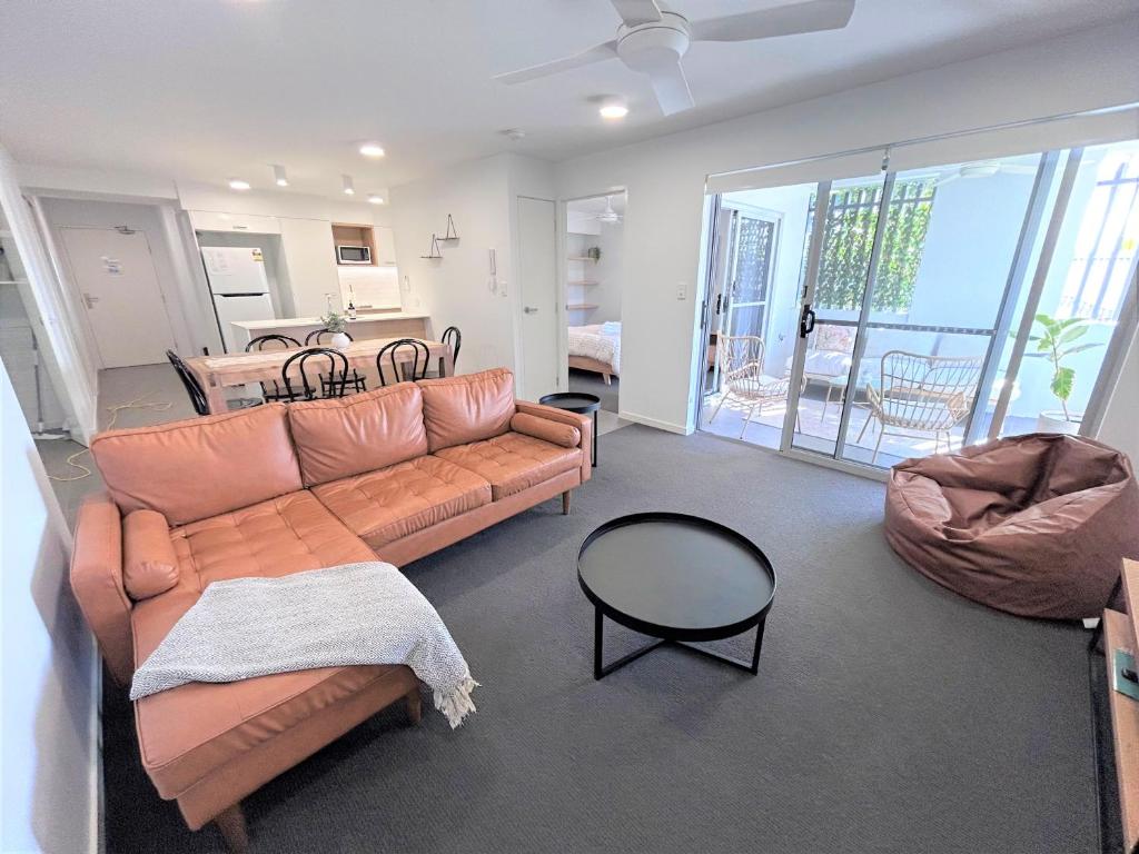 a living room with a couch and a table at Unit 3 - Manly Boutique Apartments in Brisbane