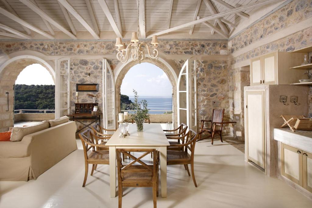 a kitchen and living room with a table and chairs at Katikies Manis in Kardamyli
