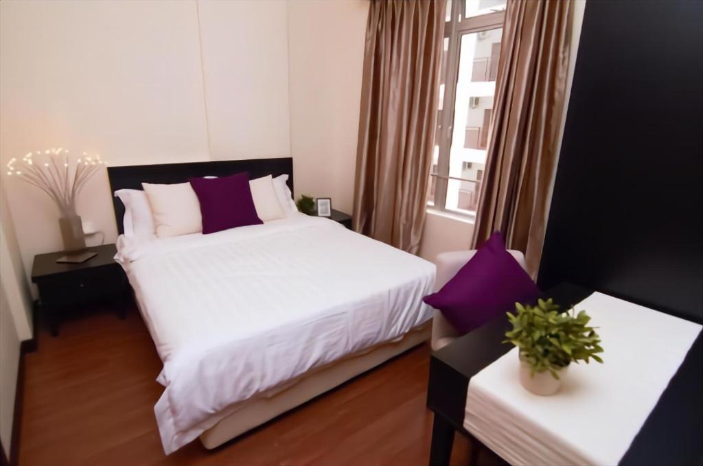 a bedroom with a white bed and a window at Melaka BY LG Water Themepark & Resort By GGM in Melaka