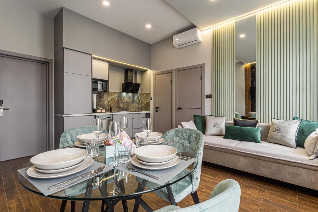 a living room with a table and a couch at Central Family Boutique Apartments 3 in Lviv