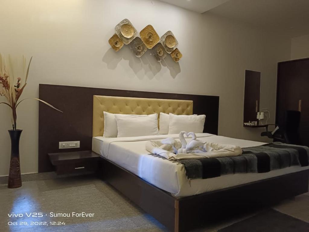 a bedroom with a large bed with clocks on the wall at Amazing Fun World By Nexottel in Dwarka