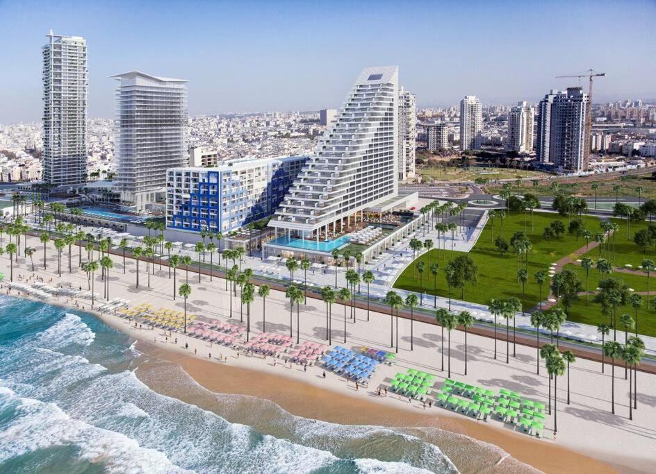 an aerial view of a beach with hotels and the ocean at near the sea even 14 days won't feel enough in Tel Aviv