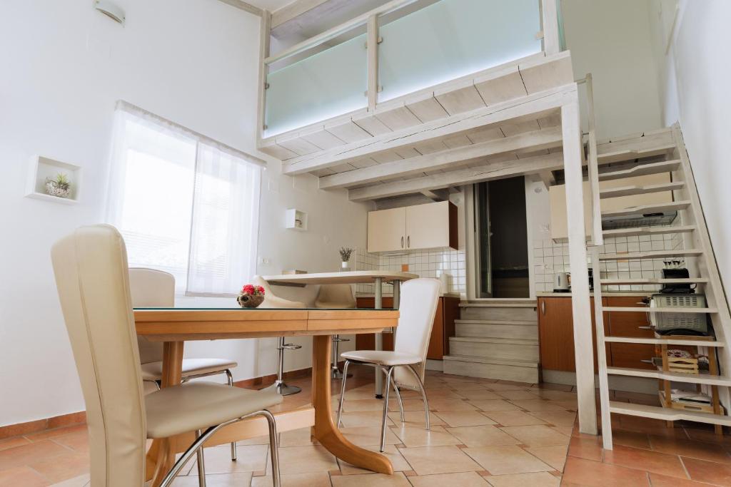 a kitchen and dining room with a table and chairs at Apartment Kanalec in Tolmin