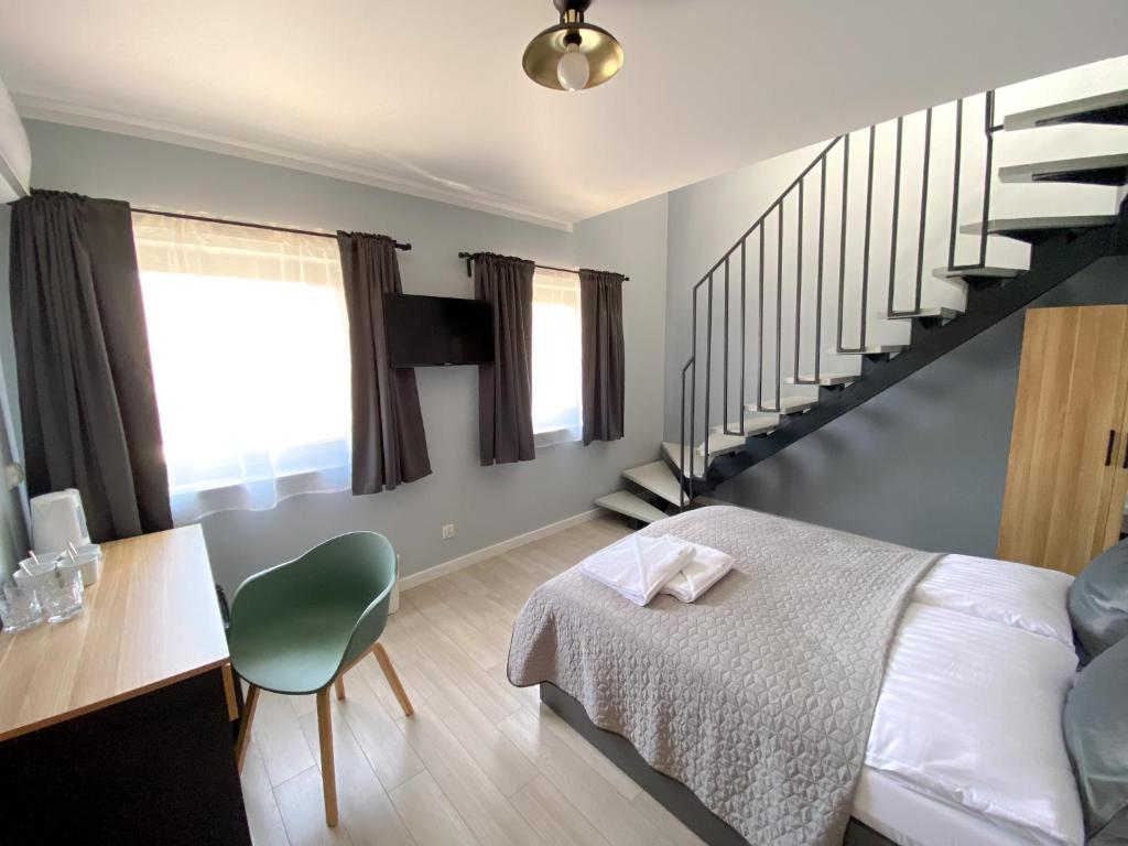 - une chambre avec un lit et un escalier dans l'établissement Prowincja Dębki, à Dębki