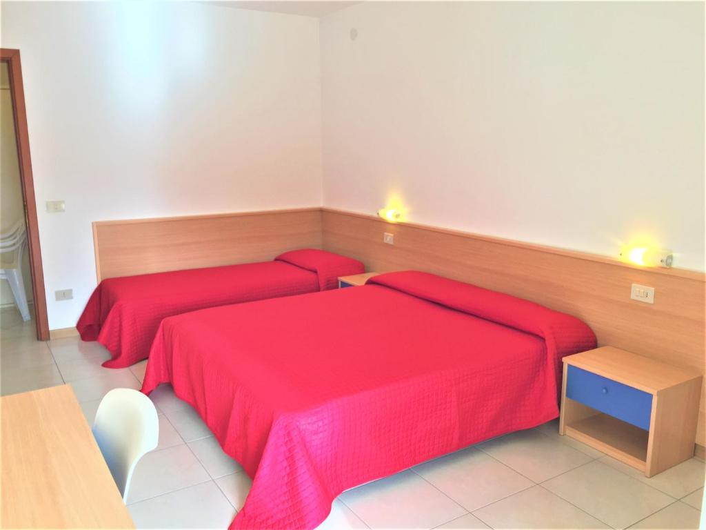 A bed or beds in a room at Bibione Residence Apartments
