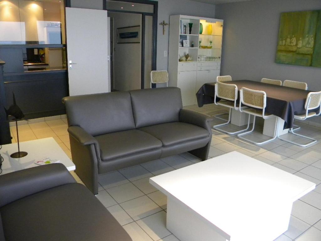 una sala de espera con sofá y mesa en Atlantic 0635, en Koksijde