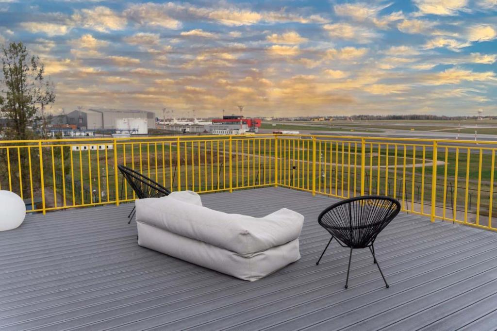 a white chair sitting on top of a balcony at Air Apartment 318 in Vilnius