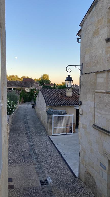 a building with a street light on the side of it at La Maison du Clocher in Saint-Émilion
