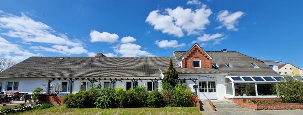 a large white house with a roof at Haus Schmidt in Alt Bukow