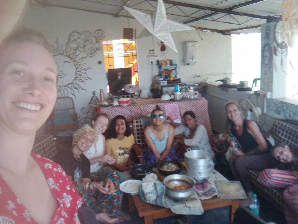 a group of people sitting in a living room at Dreamcatcher House & Hostel at Arambol Beach in Arambol