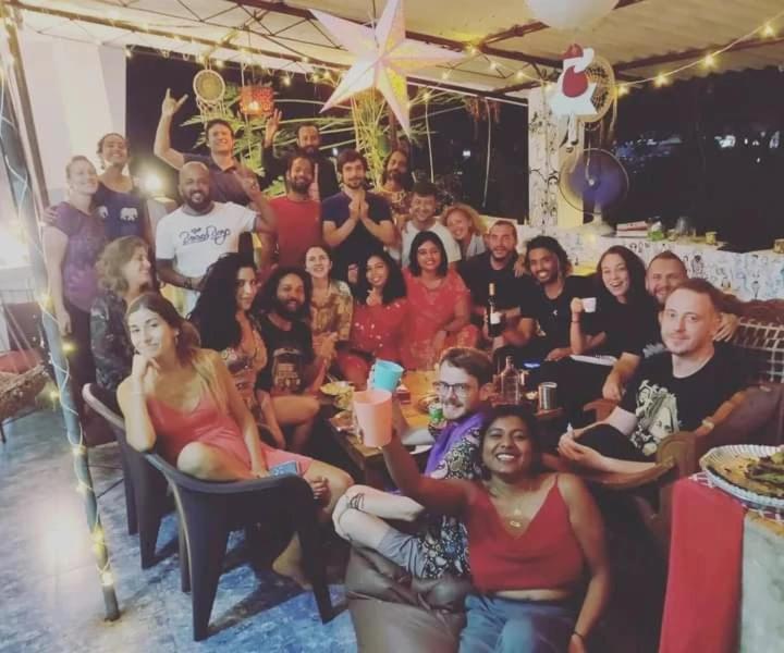 a group of people posing for a picture at a party at Dreamcatcher House & Hostel at Arambol Beach in Arambol
