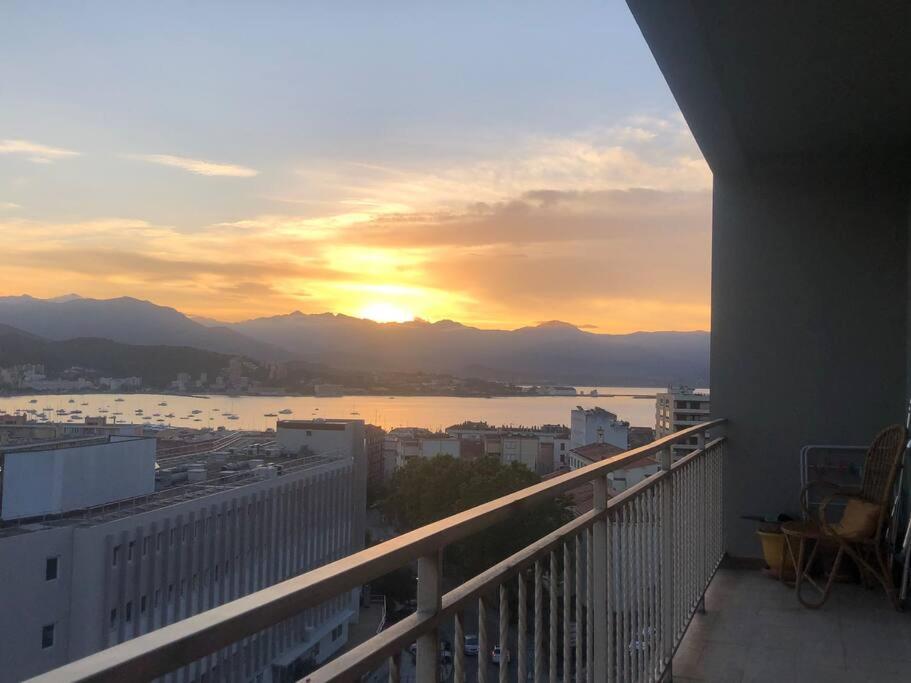 una vista su un tramonto dal balcone di un edificio di Très bel appartement avec terrasse de 87m2 avec une superbe vue panoramique sur la baie d Ajaccio ad Ajaccio