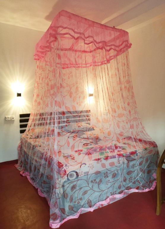 Postel nebo postele na pokoji v ubytování Maneesha Guest House