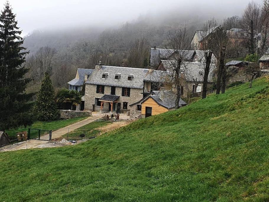 a large house on top of a green hill at Gîte d&#39;AURE. Classé en meublé 4 étoiles. 