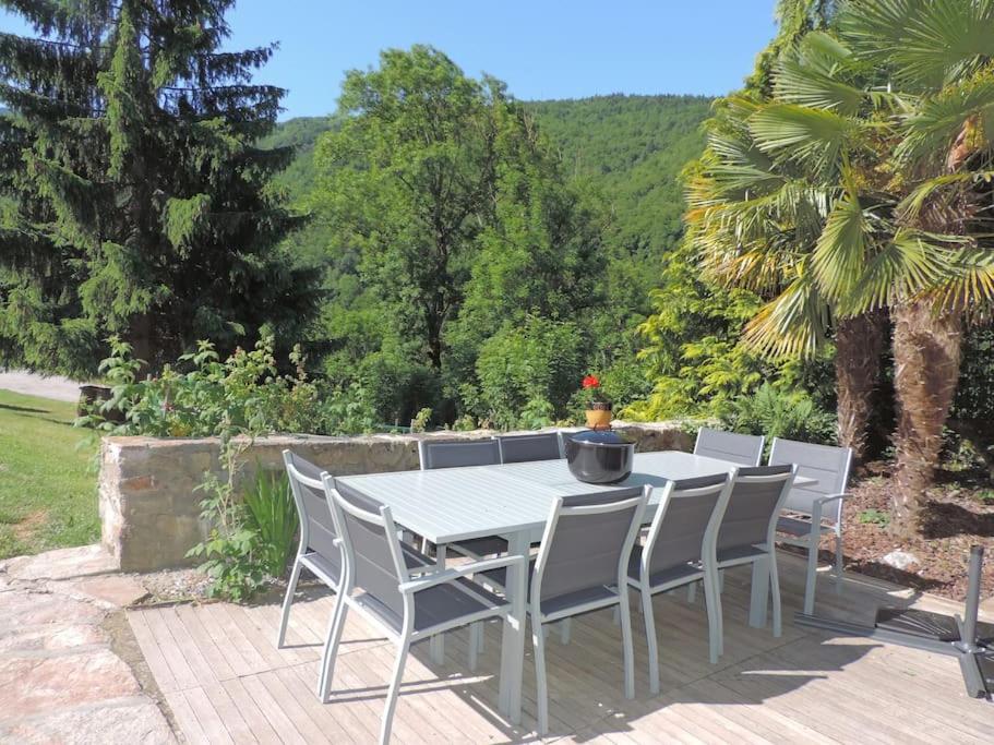 a table and chairs sitting on a patio at Gîte d&#39;AURE. Classé en meublé 4 étoiles. 