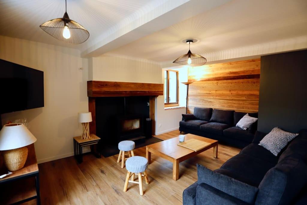 a living room with a couch and a fireplace at Gîte d&#39;AURE. Classé en meublé 4 étoiles. 