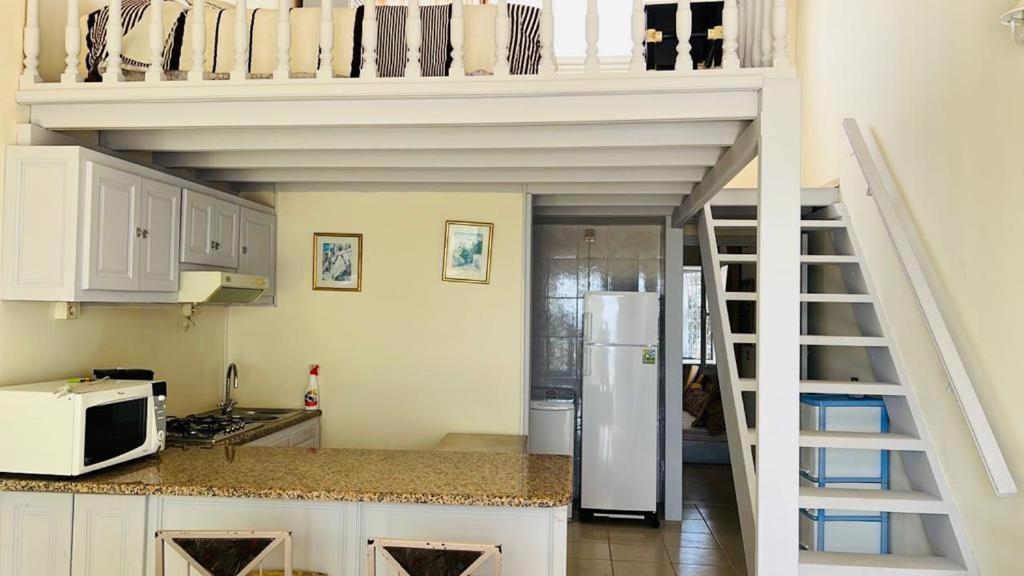 A kitchen or kitchenette at Beach house wing in kerkennah island. Fully equipped place for 4 guests and peaceful relaxing stay. Calm sea and beautiful sun rise that can be enjoyed straight on the beach or from the house terrace.