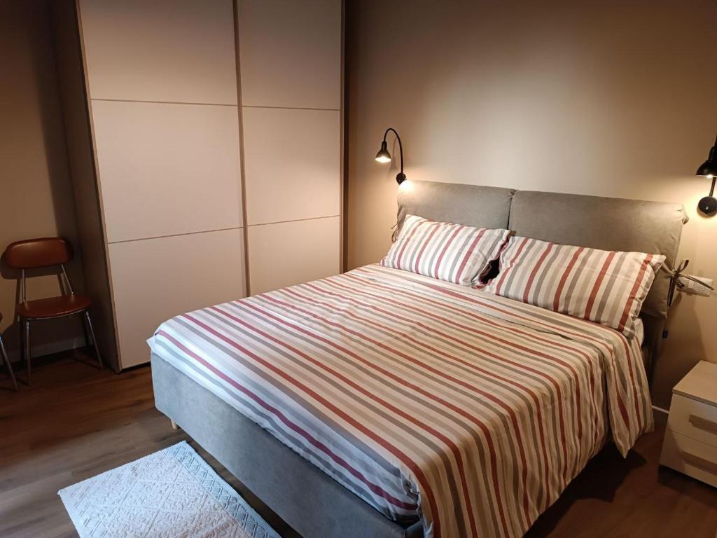 una camera con un letto con una coperta a righe di 44 Ricci ad Anghiari