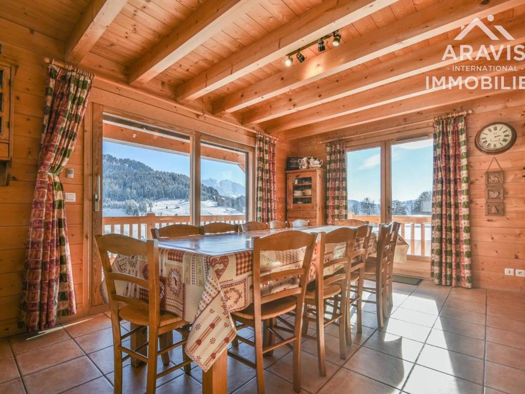a dining room with a table and chairs at Chalet Le Grand-Bornand, 7 pièces, 12 personnes - FR-1-391-30 in Le Grand-Bornand