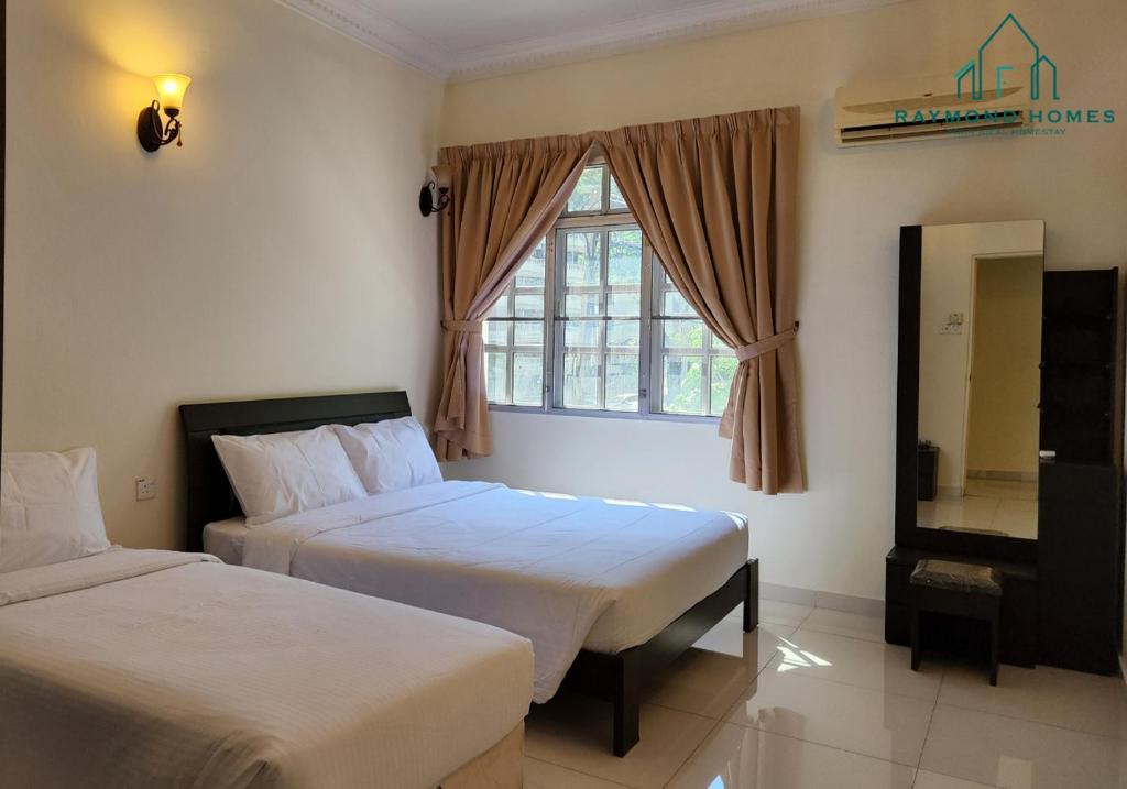a hotel room with two beds and a window at 99 Kelawei in George Town