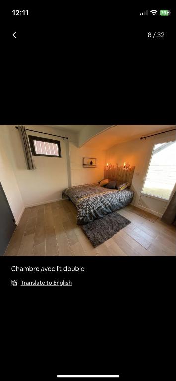 a bedroom with a bed and a window at Petite maison chaleureuse des boucles de la Seine in Le Mesnil-sous-Jumièges