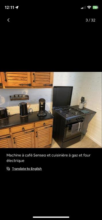 a kitchen with a stove and a stove top oven at Petite maison chaleureuse des boucles de la Seine in Le Mesnil-sous-Jumièges