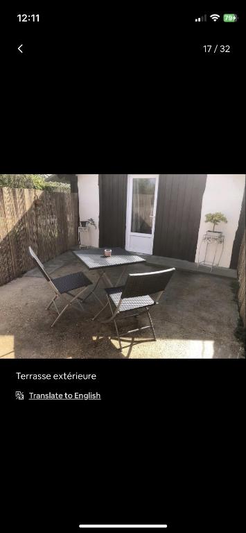 a picture of a table and a chair in a room at Petite maison chaleureuse des boucles de la Seine in Le Mesnil-sous-Jumièges