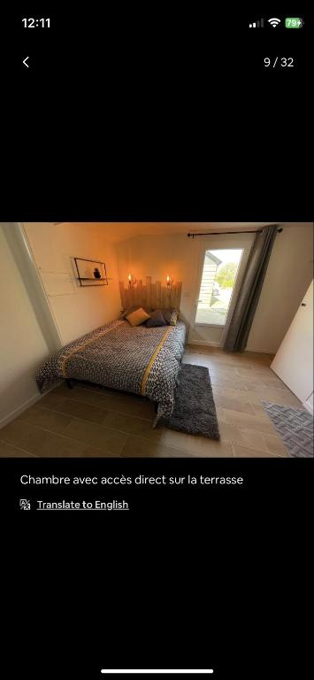 a bedroom with a bed and a window at Petite maison chaleureuse des boucles de la Seine in Le Mesnil-sous-Jumièges