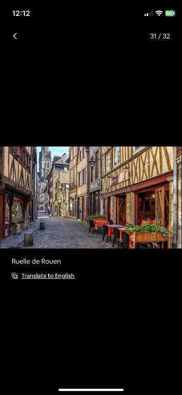 a picture of a city street with tables and buildings at Petite maison chaleureuse des boucles de la Seine in Le Mesnil-sous-Jumièges