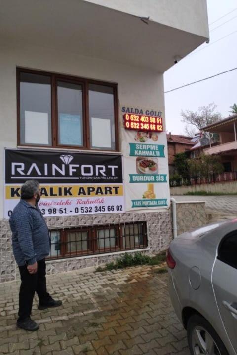 a man standing in front of a building at RAINFORT APART salda gölü kiralık apart in Yeşilova