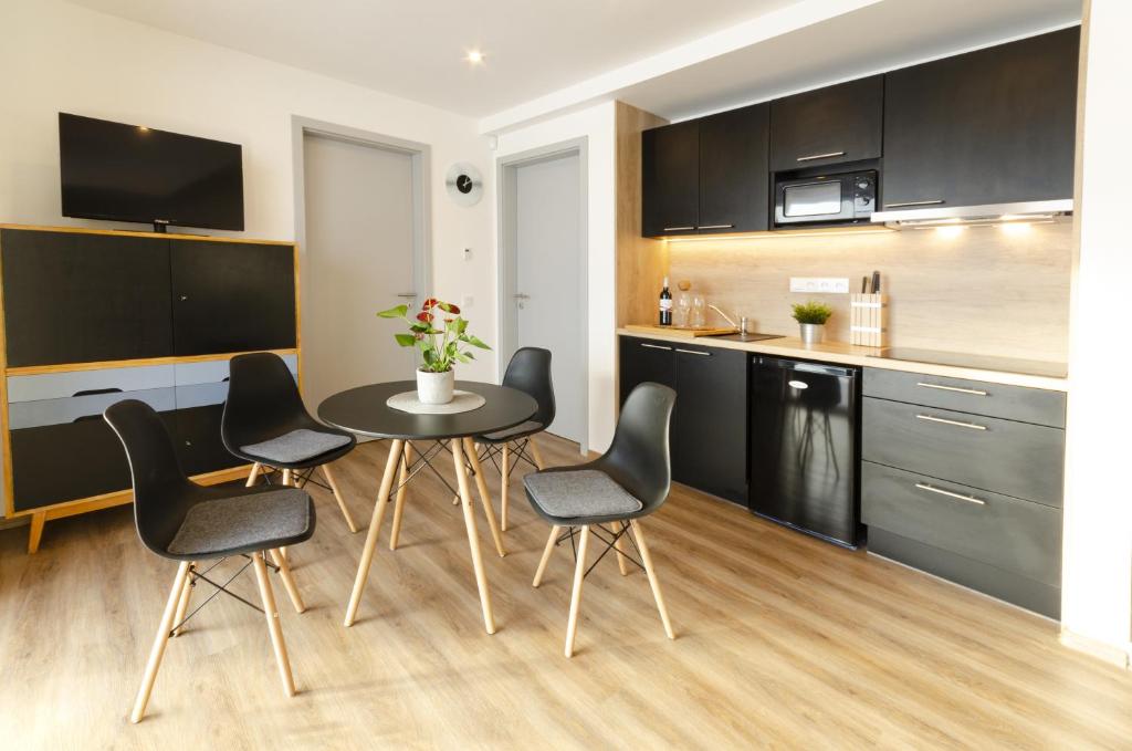 a kitchen with a table and chairs in a room at Nepomuk pod Prahou 