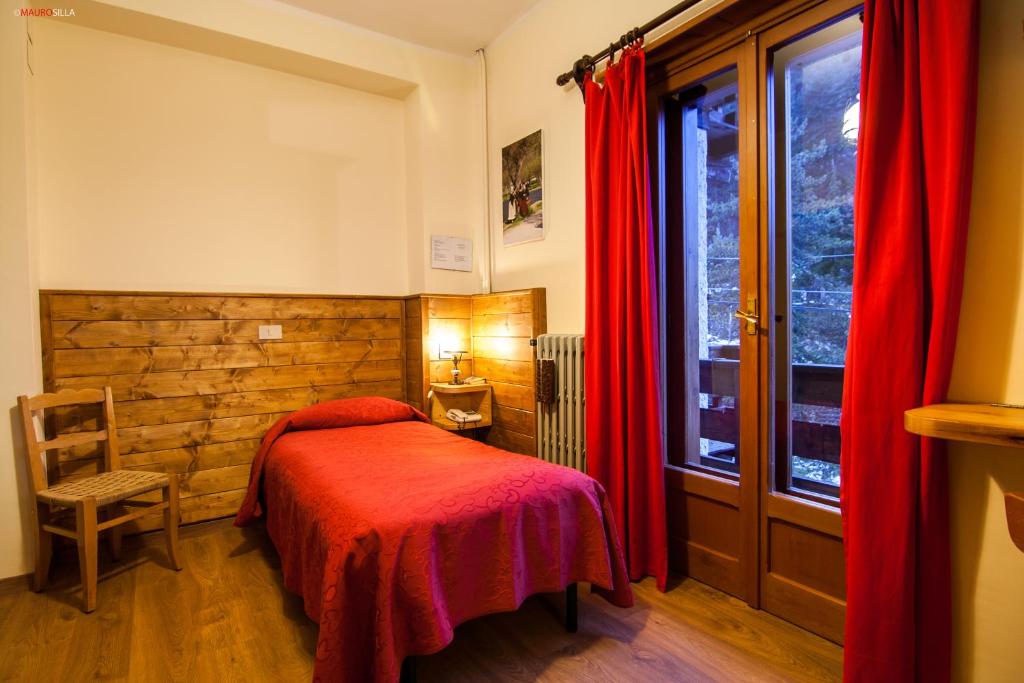 Postel nebo postele na pokoji v ubytování Hotel Garnì Mille Pini