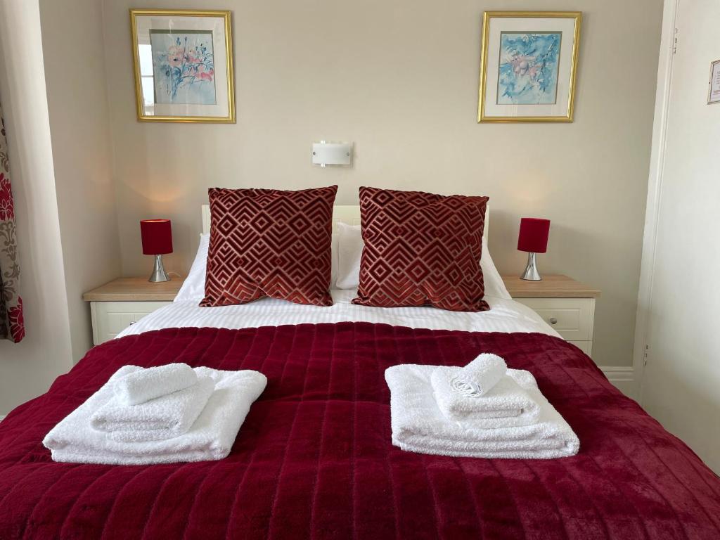 a bedroom with a bed with white towels on it at The Sandrock in Clacton-on-Sea