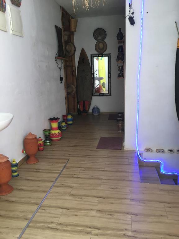 a room filled with lots of different colored vases at EL Faro Surfstay in Tamri