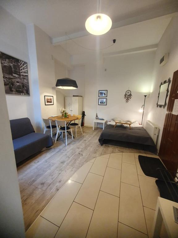 a living room with a couch and a table at Stara Poczta Apartament in Sokołowsko