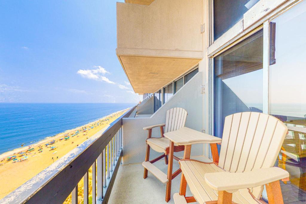 two chairs on a balcony overlooking the beach at Century I 1622 in Ocean City