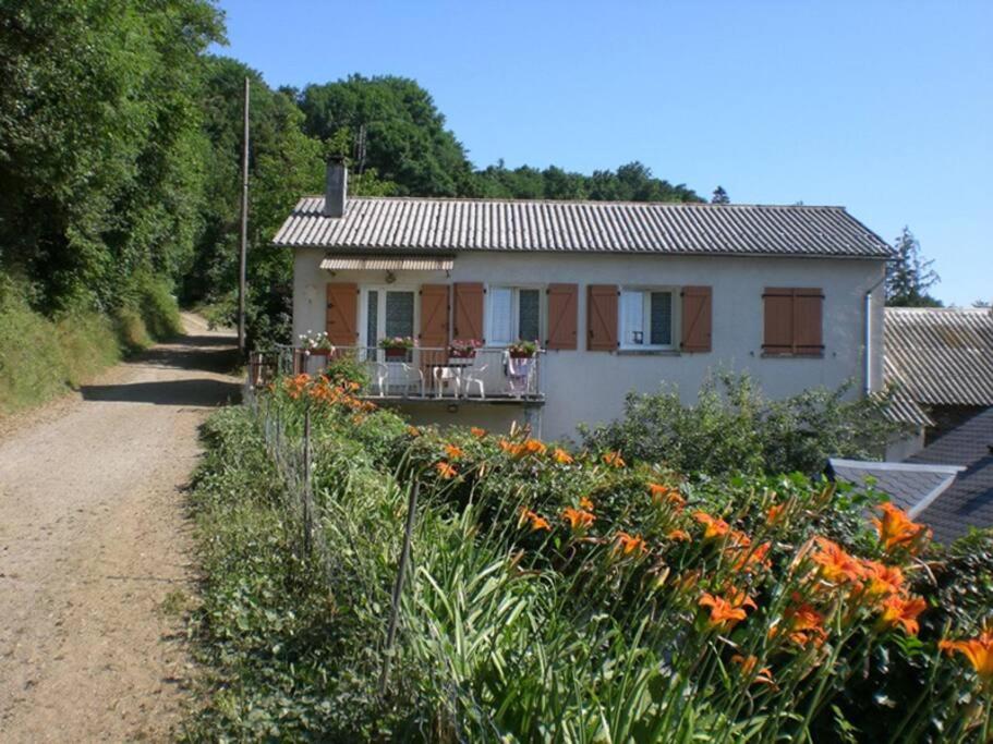 a house with orange flowers in front of it at Gîte Saint Michel 2 étoiles in Moulin-Mage