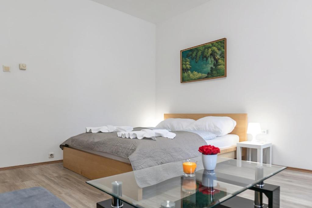 a bedroom with a bed and a glass table at Spacious & Pleasent 2BR Apt. near Milenium Tower in Vienna