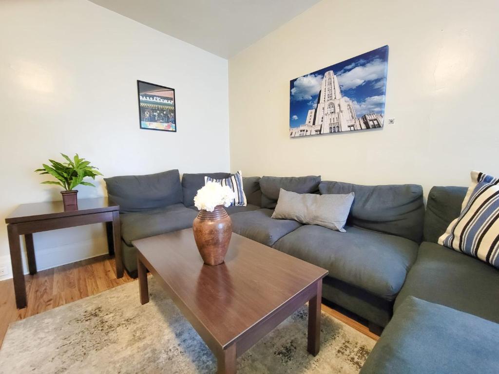 a living room with a couch and a coffee table at Steps Away From Hospital - 2 Queen Bed - City View in Pittsburgh