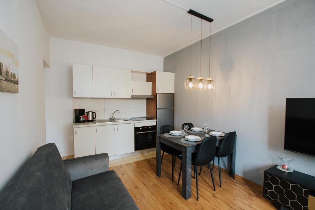 a small kitchen and dining room with a table and chairs at Apartment Deni in Solin