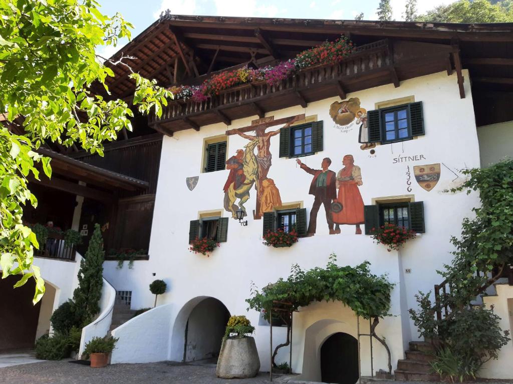 a building with a mural on the side of it at Agriturismo Sittnerhof in Merano