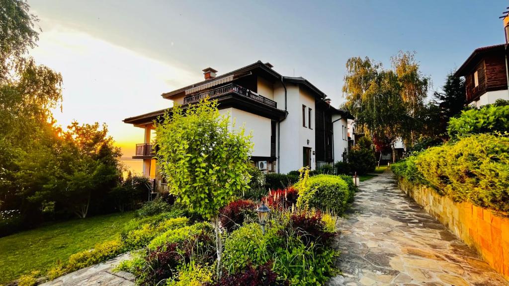 a house with a garden in front of it at Cozy Home Santa Marina in Sozopol
