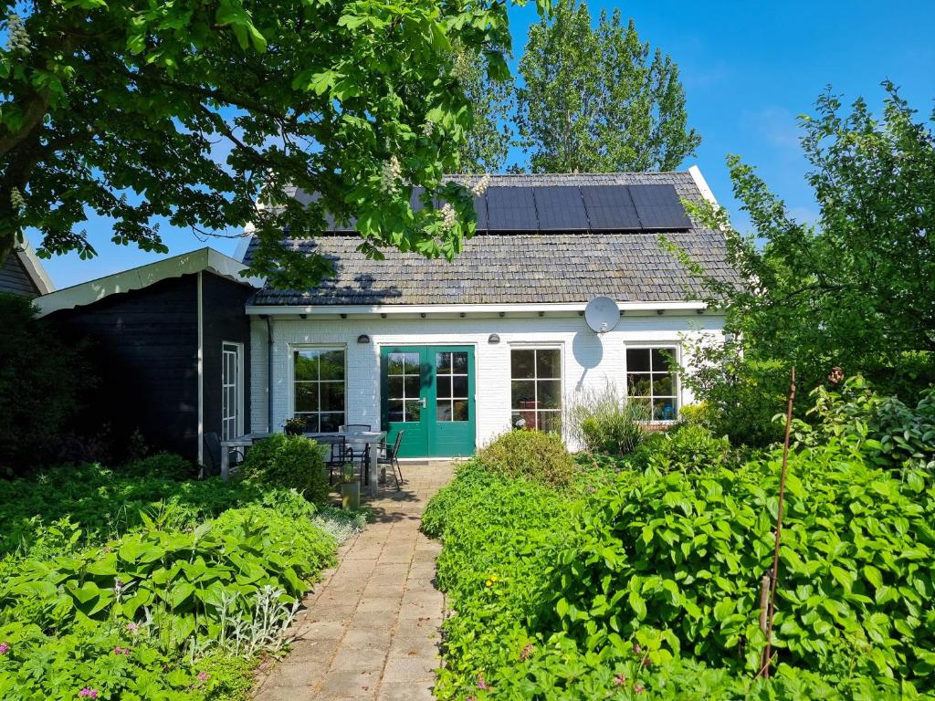 a white house with solar panels on the roof at Vakantiehuis Oostkapelle OK41 in Oostkapelle