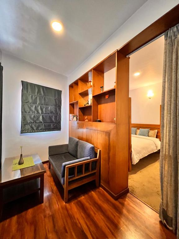 een woonkamer met een bank en een bed bij Your home in Kathmandu! in Kathmandu