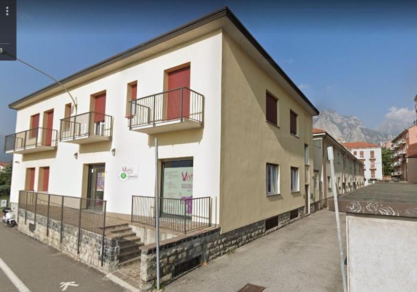 a building with balconies on the side of it at Grandi Cime Guest House in Lecco