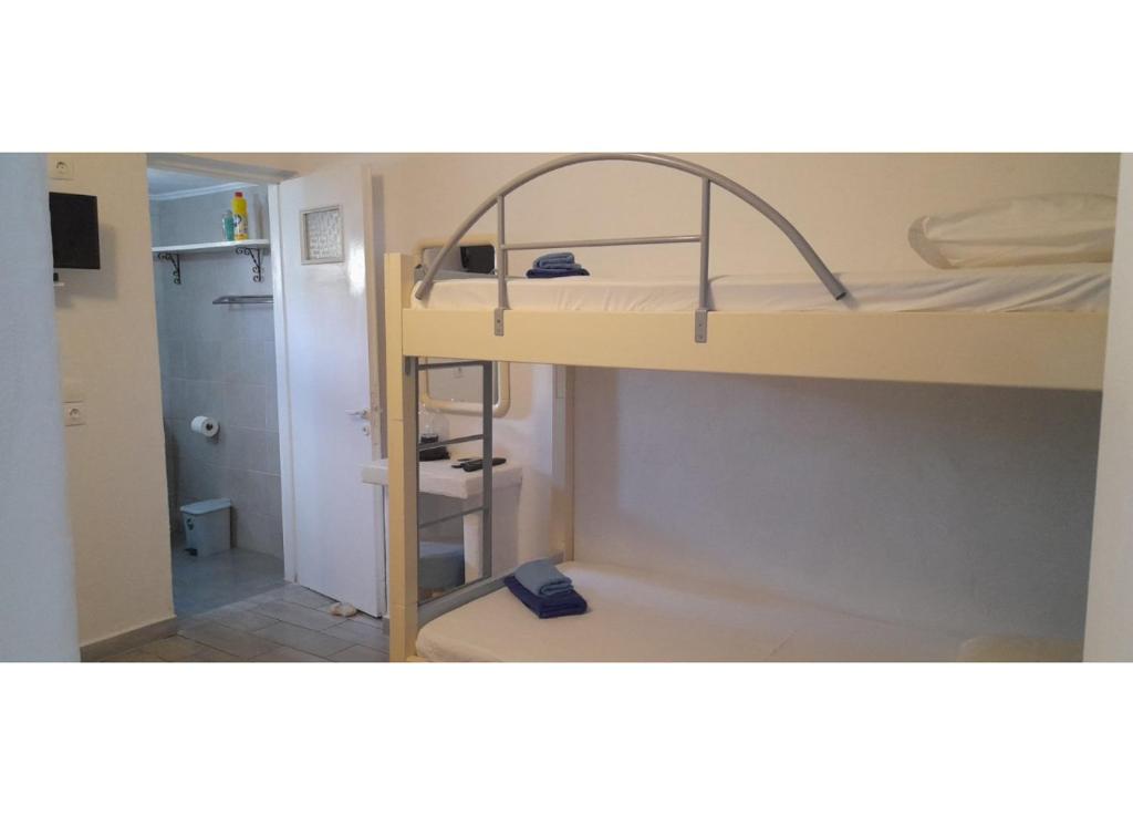 a small room with a bunk bed and a bathroom at Summer House Paliochori in Paliochori
