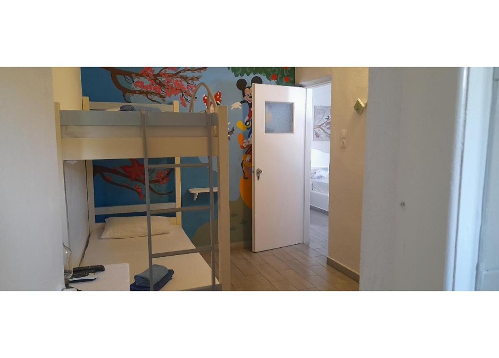 a room with a bedroom with a bunk bed and a door at Summer House Paliochori in Paliochori