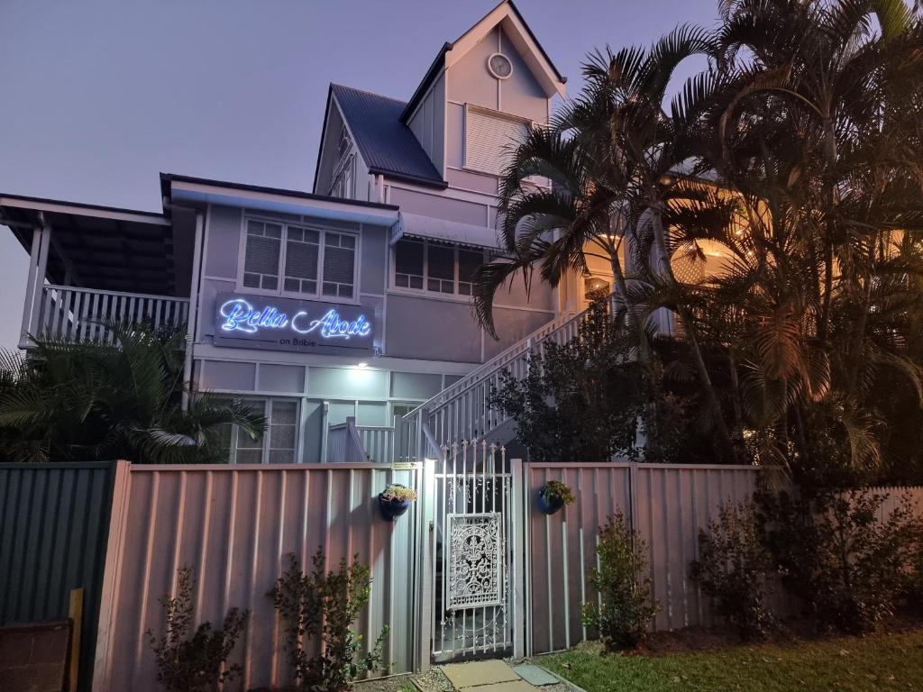 a pink house with a gate and a fence at Bella Abode on Bribie - Loft with Pool in Bongaree