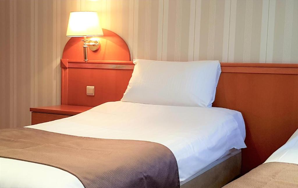 Postel nebo postele na pokoji v ubytování Hotel Cardinal