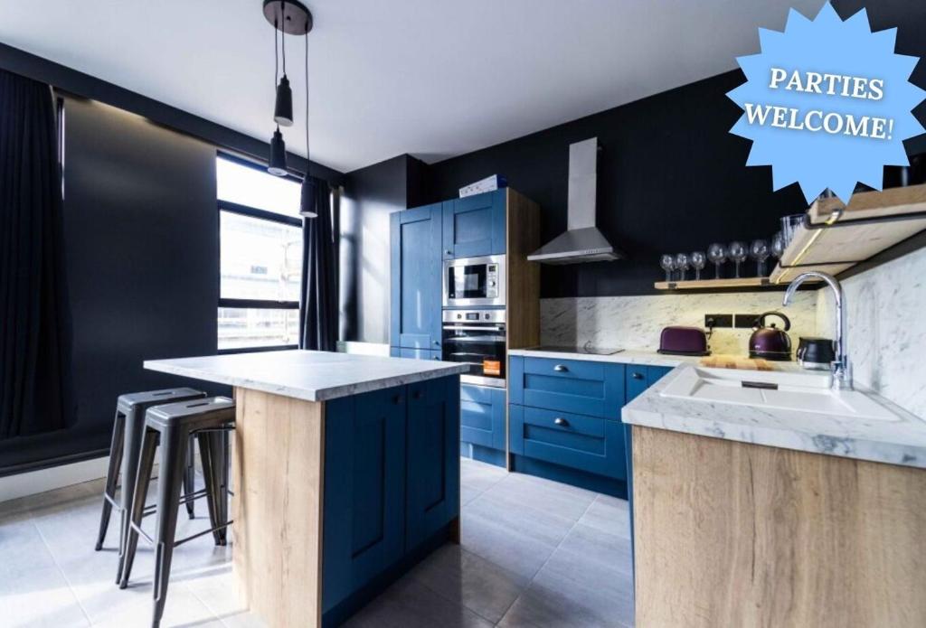 a kitchen with blue cabinets and a counter top at Luxury Blackpool Apartments by Sasco in Blackpool